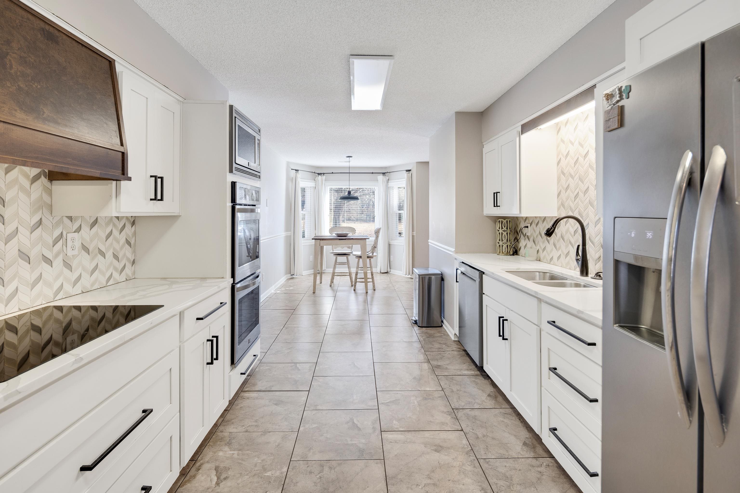 3888 Appling Road Bartlett, TN 38135 - Photo 10 of 21 a large kitchen with stainless steel appliances granite countertop a sink stove and refrigerator