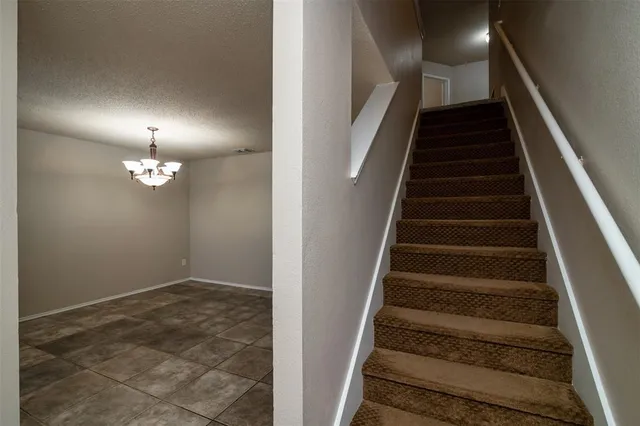 wooden floor in an empty room with stairs