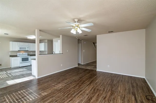 a view of a kitchen with wooden floor and a kitchen space