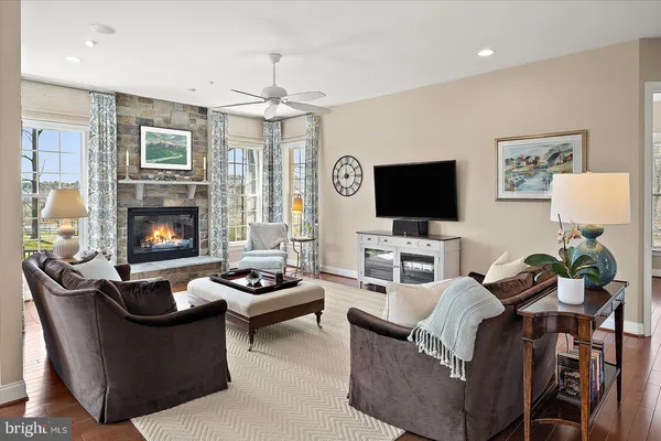 a dining room with furniture wooden floor and a chandelier
