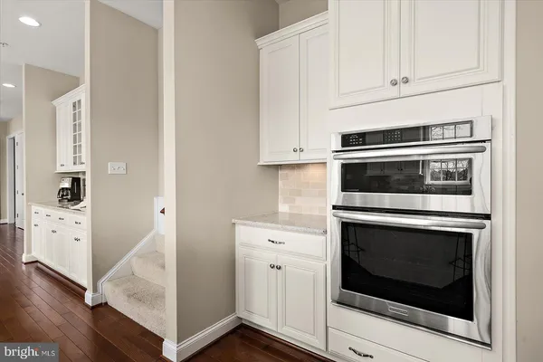 a spacious bathroom with a granite countertop sink and a mirror