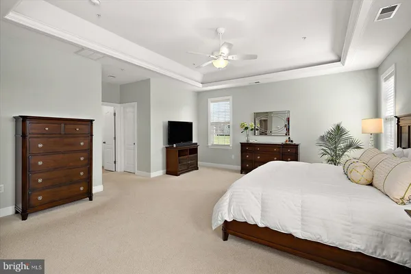 a living room with furniture a flat screen tv and a window