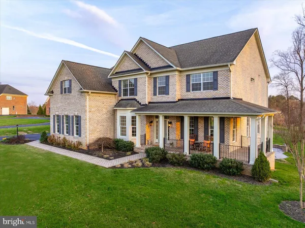 a front view of a house with a yard and porch