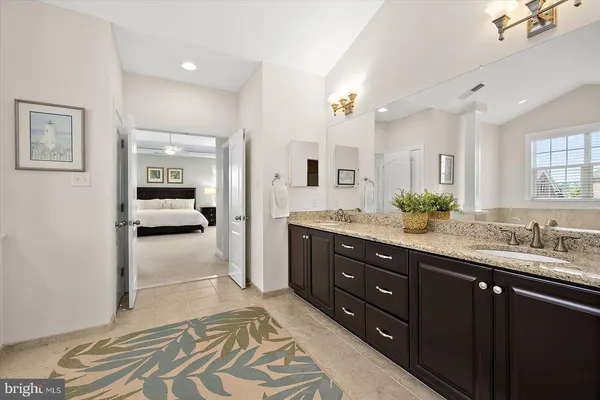 a view of a patio with table and chairs with wooden floor and fence