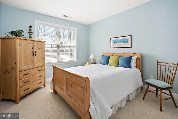 a view of a house next to a big yard and large trees