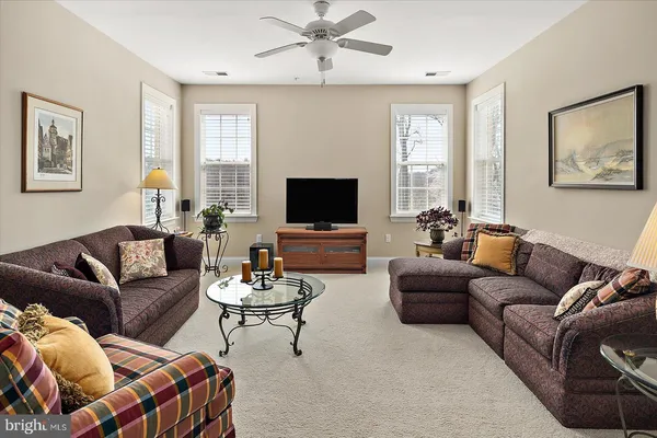 a view of a patio with couches chairs and wooden floor