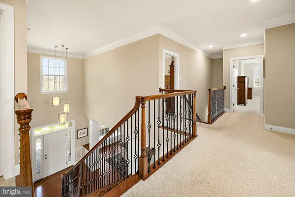 a view of a big house with a big yard and large trees