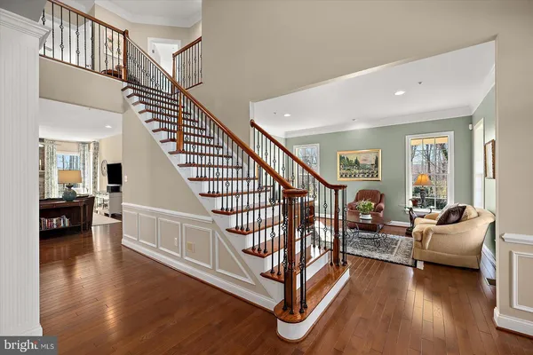 a living room with furniture fireplace and a large window
