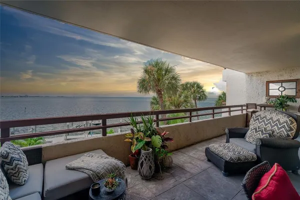a roof deck with couches and potted plants