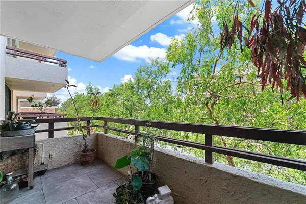 a view of a balcony with chairs