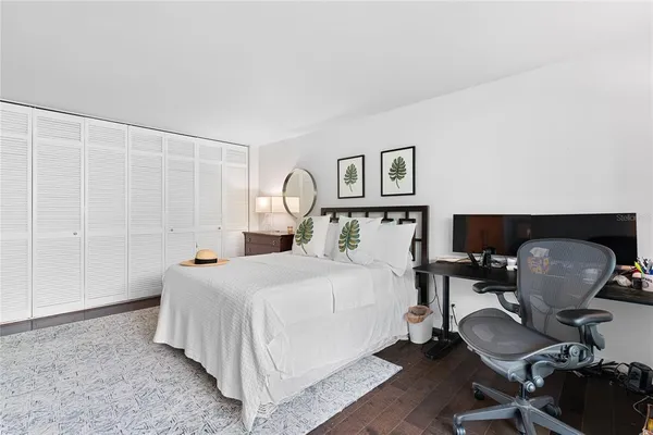 a bedroom with a bed chair and a window