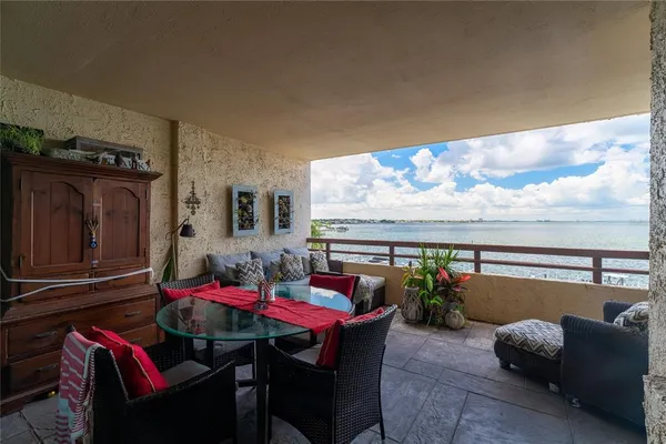 a living room with furniture a flat screen tv and a floor to ceiling window