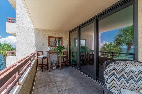 a balcony with furniture and a table