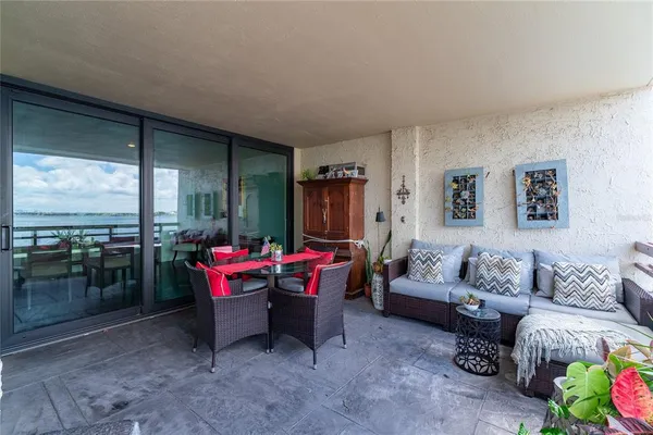 a living room with furniture and a floor to ceiling window