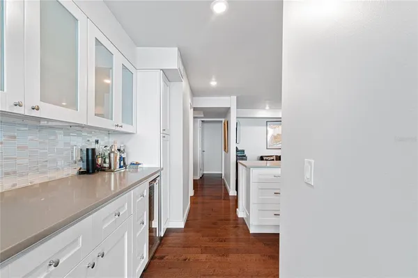 a kitchen with refrigerator and cabinets