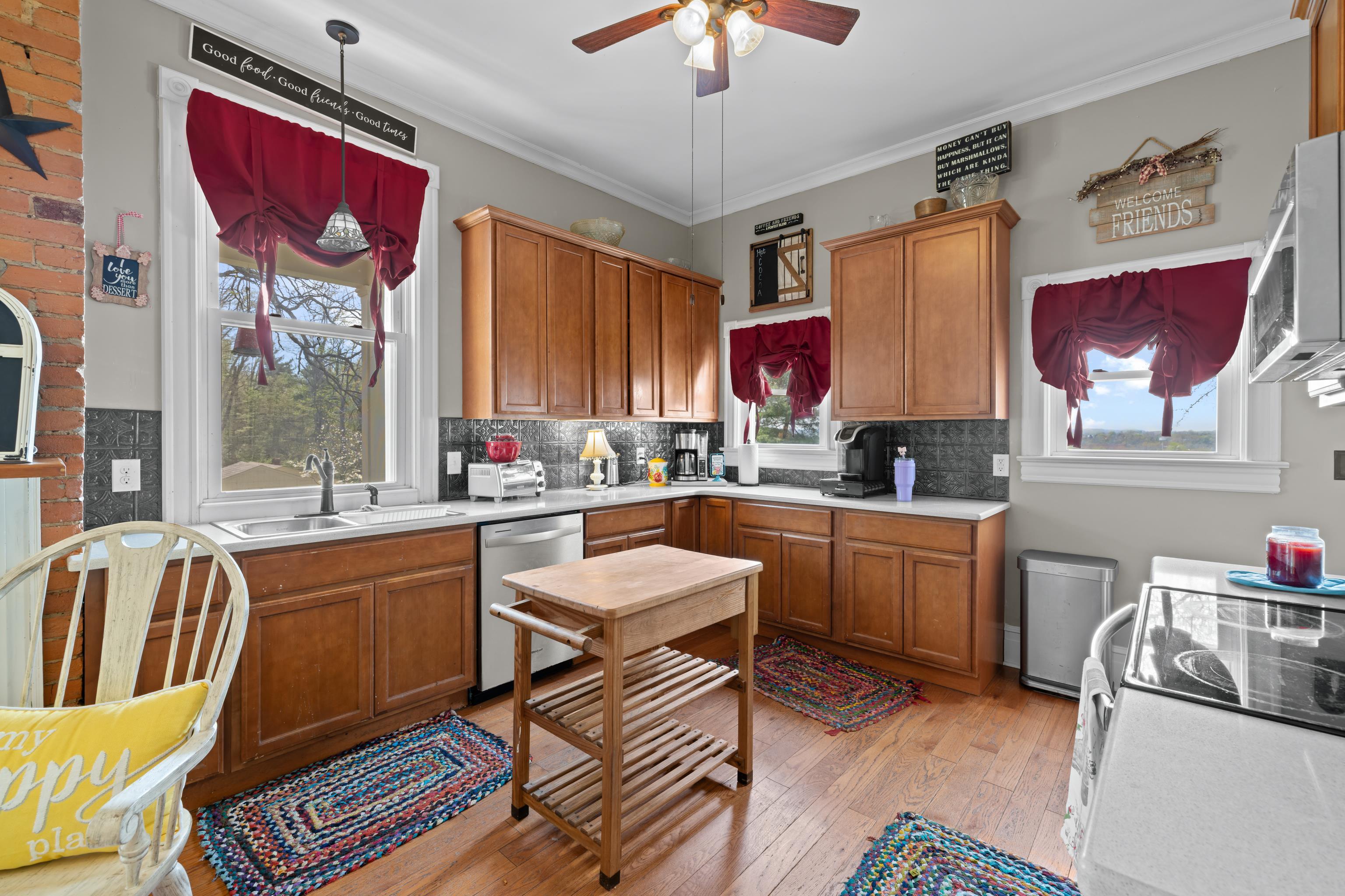 1224 4th Street Waynesboro, VA 22980 - Photo 23 of 75 a kitchen with a refrigerator a stove a sink dishwasher with a dining table and chairs with wooden floor