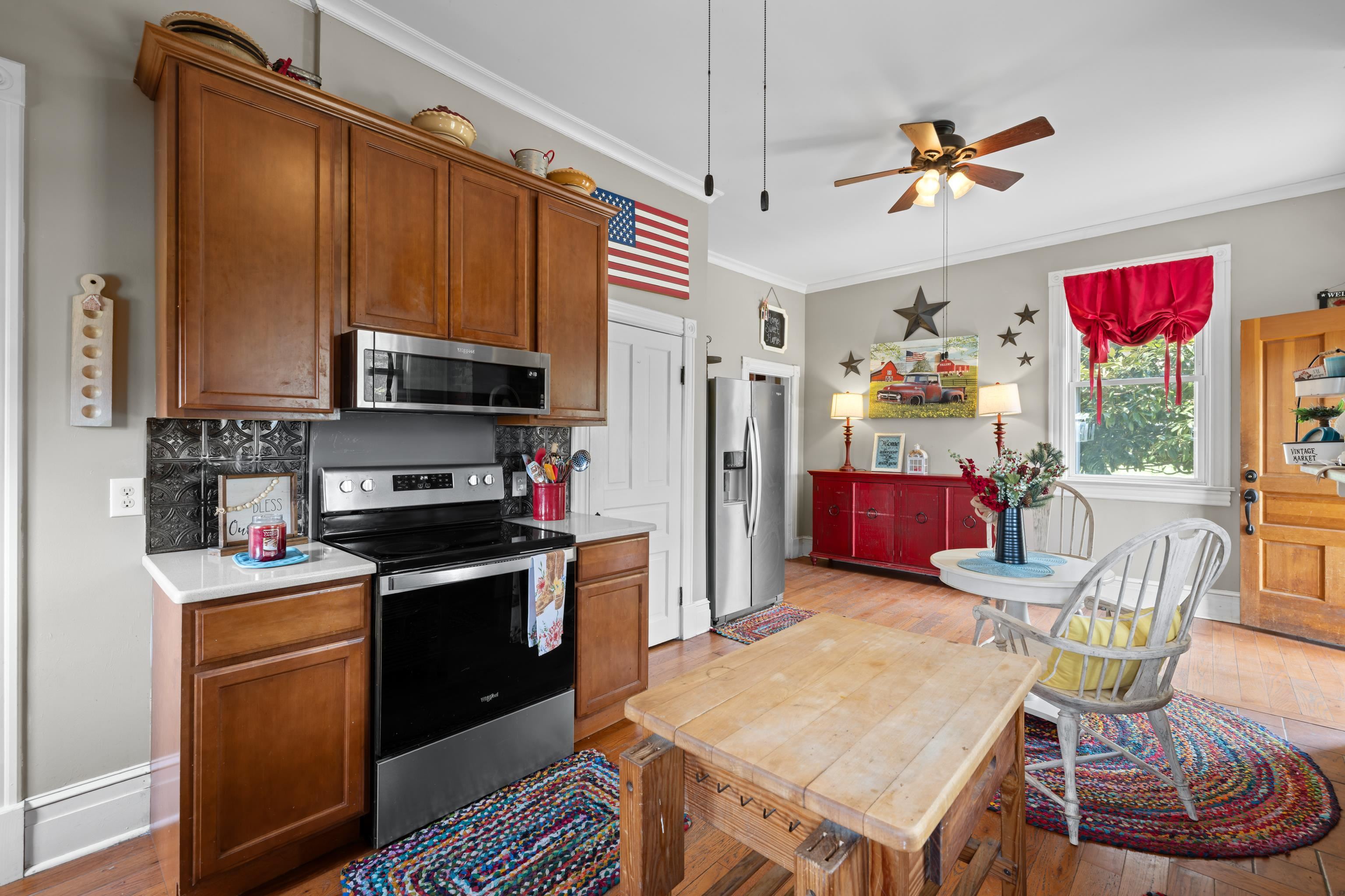 1224 4th Street Waynesboro, VA 22980 - Photo 28 of 75 a kitchen with stainless steel appliances granite countertop a stove refrigerator a kitchen island a dining table and chairs with wooden floor