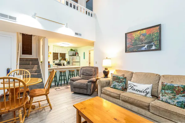 a dining hall with stainless steel appliances a dining table and chairs