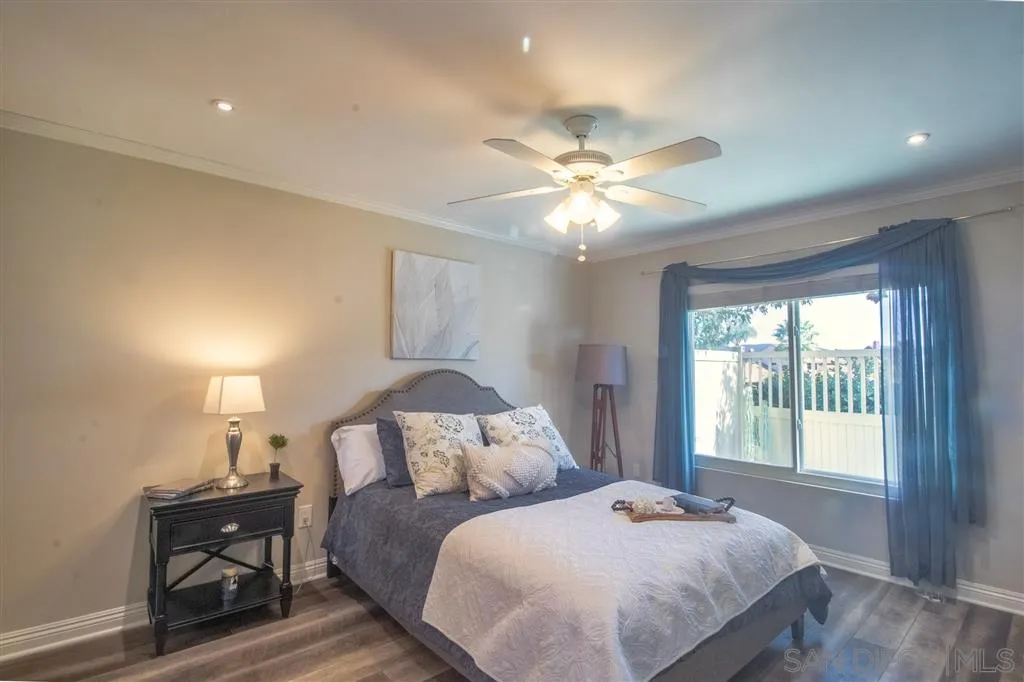 8803 Capcano Road San Diego, CA 92126 - Photo 11 of 24 a bedroom with a bed and a chandelier