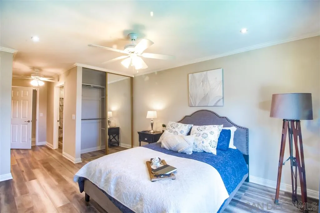 8803 Capcano Road San Diego, CA 92126 - Photo 3 of 24 a bedroom with a bed and a chandelier