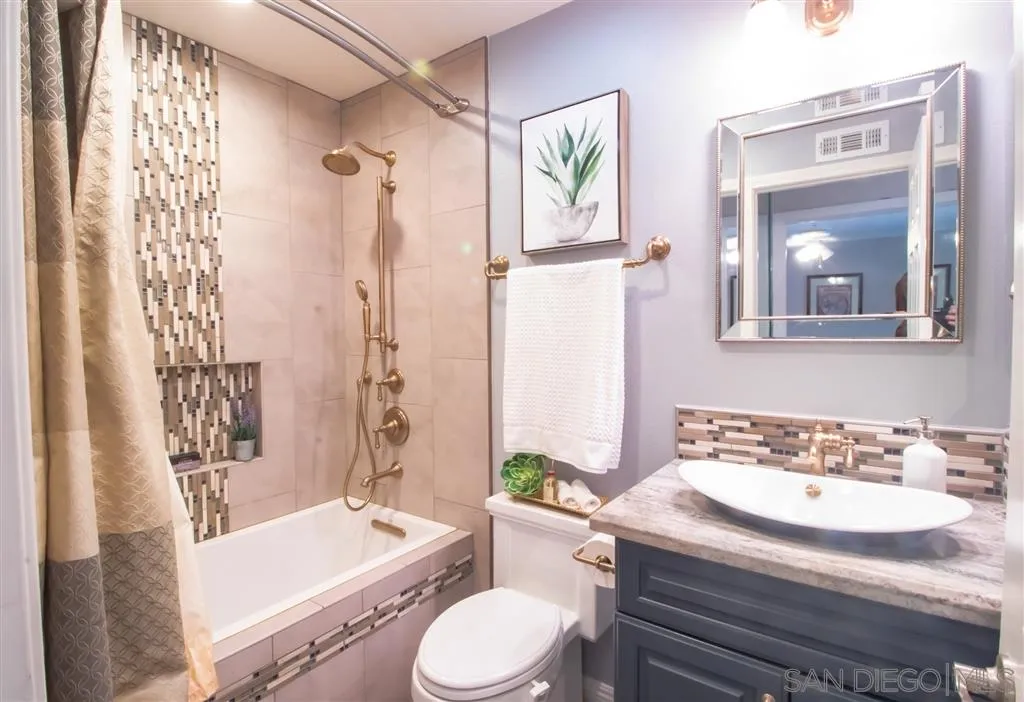 8803 Capcano Road San Diego, CA 92126 - Photo 8 of 24 a bathroom with a granite countertop sink toilet and a bathtub