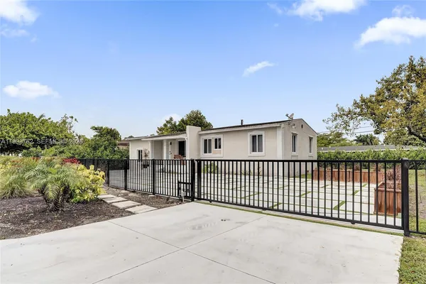 a view of a house with a fence