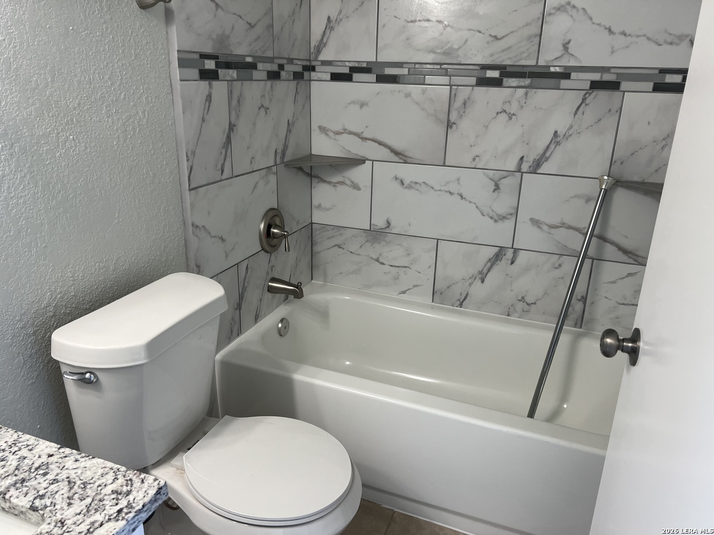 108-110 Whisper Way Boerne, TX 78006 - Photo 11 of 15 a white toilet sitting next to a bath tub