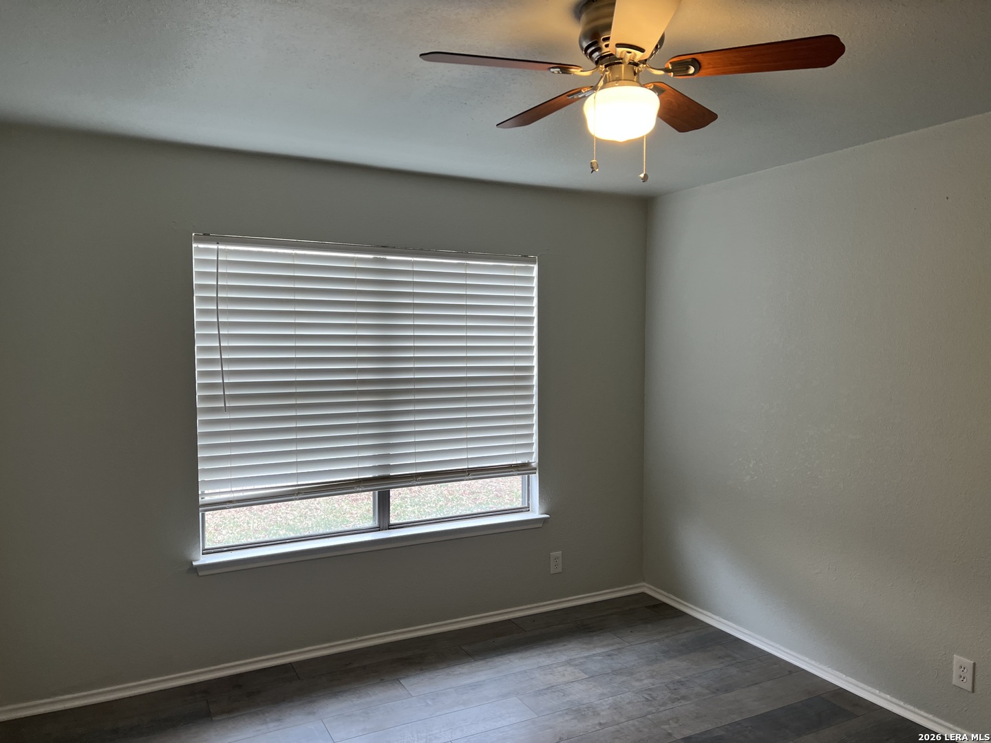 108-110 Whisper Way Boerne, TX 78006 - Photo 7 of 15 an empty room with a window and a fan