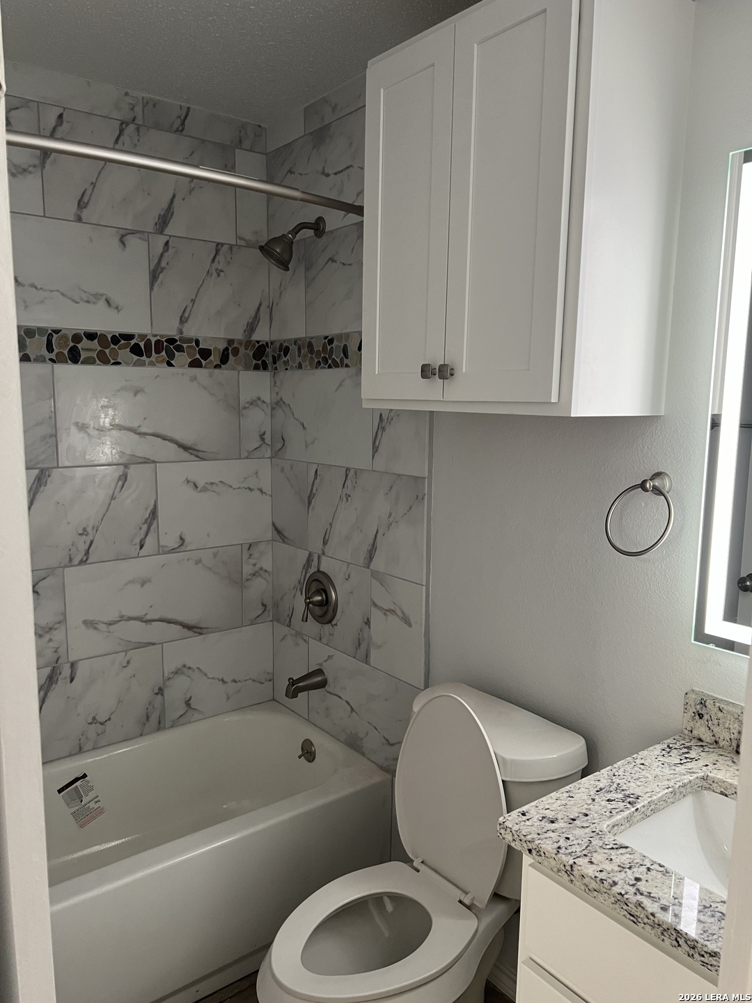 108-110 Whisper Way Boerne, TX 78006 - Photo 9 of 15 a bathroom with a granite countertop toilet sink and bathtub