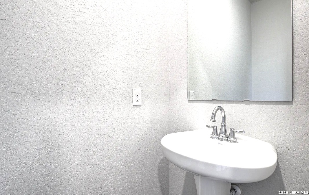 2563 Rambo Drive San Antonio, TX 78224 - Photo 19 of 21 a bathroom with a sink and a mirror