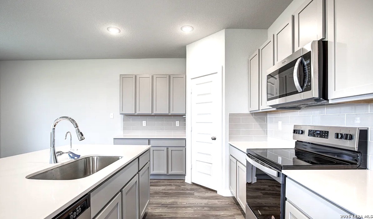 2563 Rambo Drive San Antonio, TX 78224 - Photo 3 of 21 a kitchen with stainless steel appliances granite countertop a sink stove and cabinets