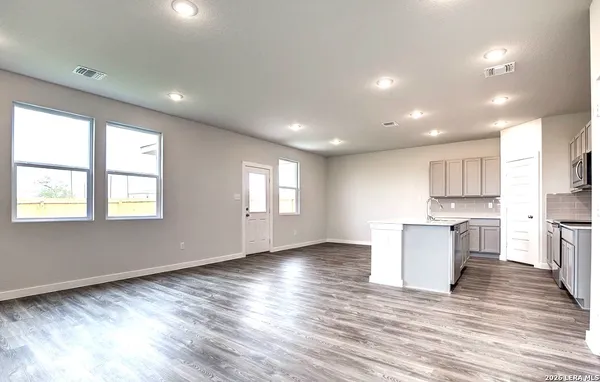 a view of kitchen with wooden floor and electronic appliances