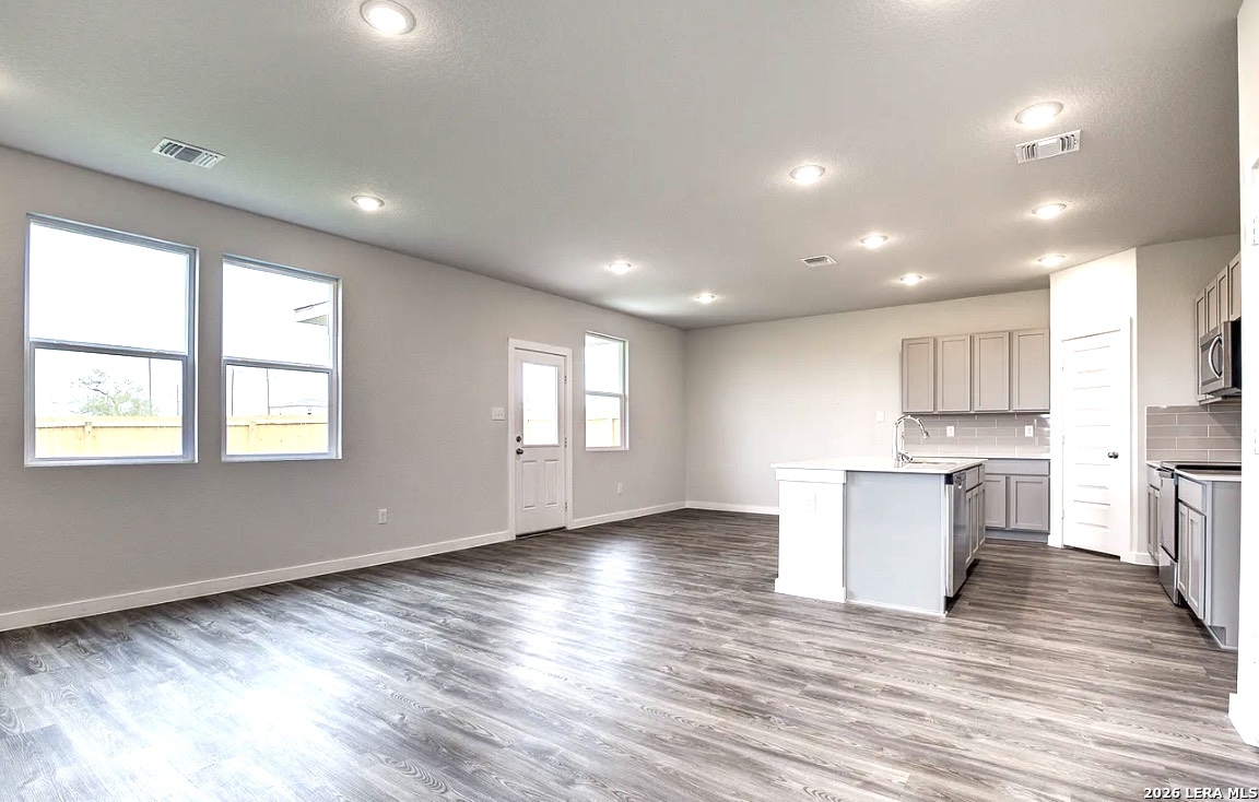 2563 Rambo Drive San Antonio, TX 78224 - Photo 4 of 21 a view of kitchen with wooden floor and electronic appliances