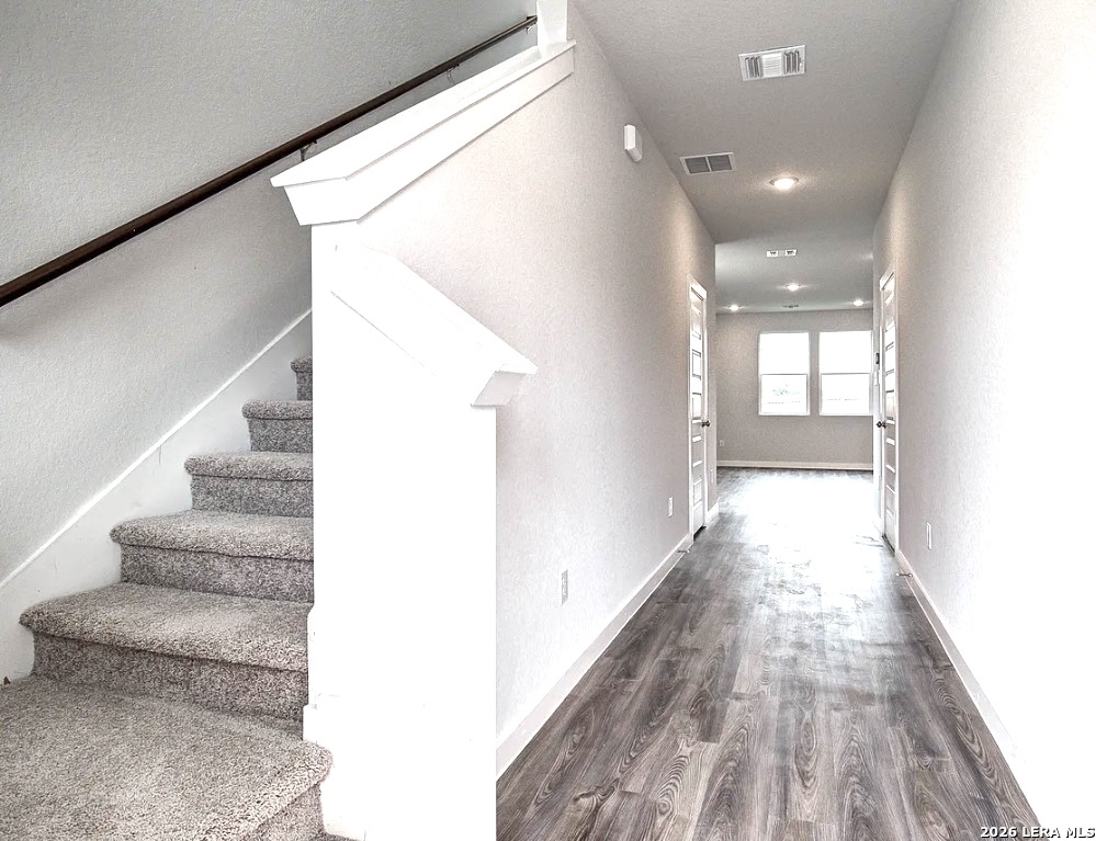 2563 Rambo Drive San Antonio, TX 78224 - Photo 7 of 21 a view of a hallway with wooden floor and staircase