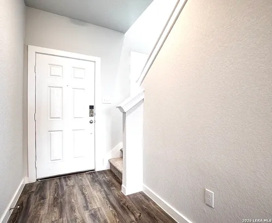 a view of hallway with wooden floor