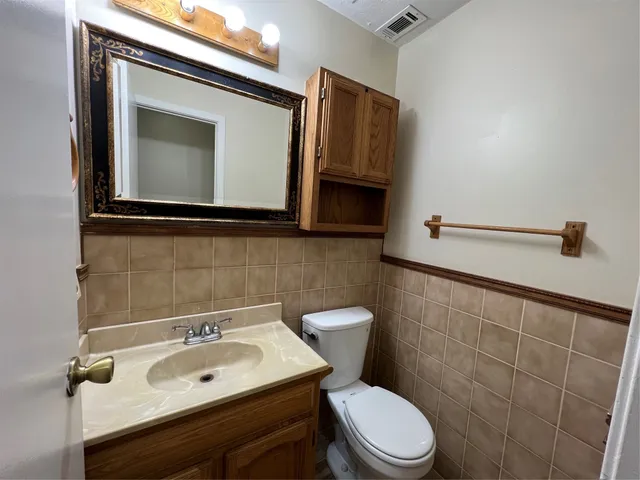 a bathroom with a sink toilet and mirror