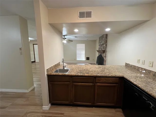 a bathroom with a granite countertop sink a large mirror and vanity