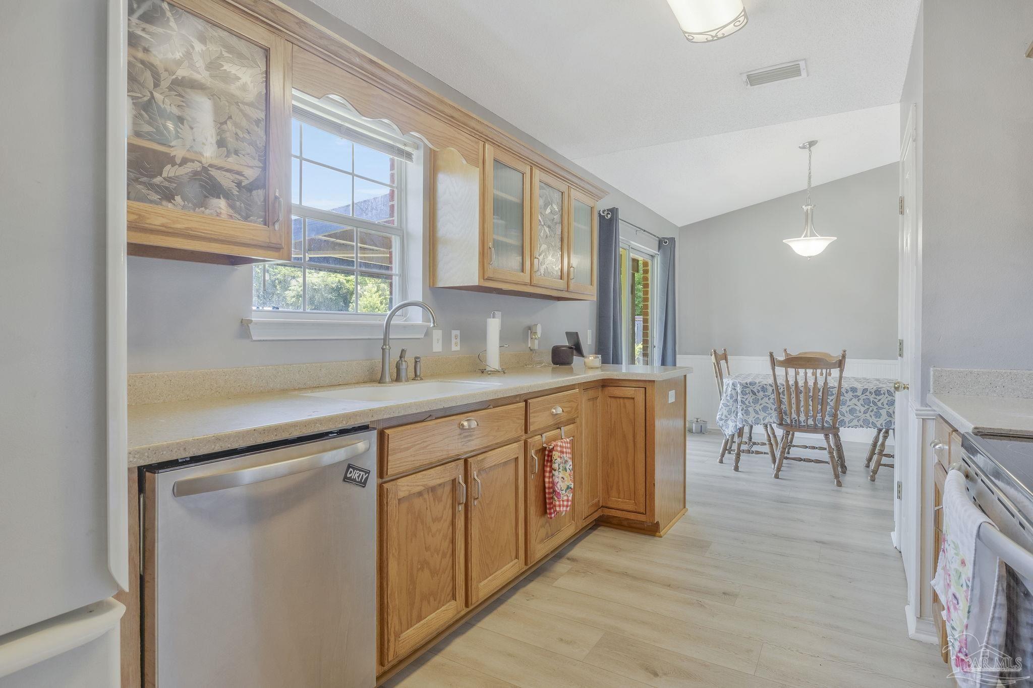 5539 Windrun Place Pace, FL 32571 - Photo 2 of 62 a kitchen with stainless steel appliances granite countertop a sink and a refrigerator