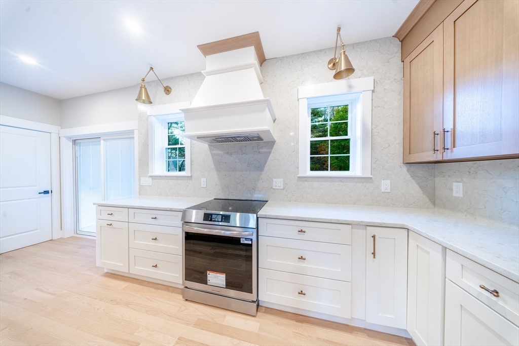 292 Main Street Norfolk, MA 02056 - Photo 4 of 42 a kitchen with stainless steel appliances a stove sink and cabinets