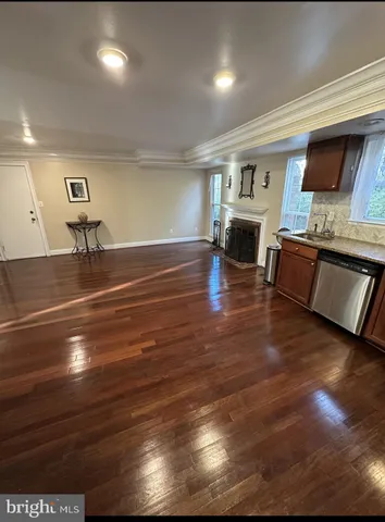 a living room with fireplace furniture and a wooden floor