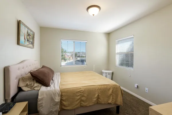 a bedroom with a bed and a window