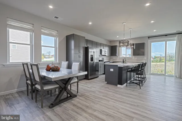 a view of a dining room with furniture window and wooden floor