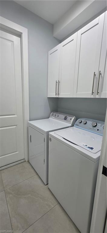 598 2nd Street Southeast Naples, FL 34117 - Photo 28 of 40 Laundry room with cabinet space and washing machine and clothes dryer