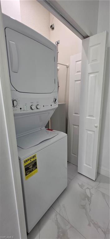 598 2nd Street Southeast Naples, FL 34117 - Photo 31 of 40 Laundry room featuring light marble finish floors and estacked washer and dryer