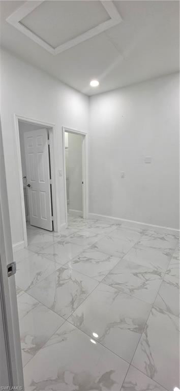 598 2nd Street Southeast Naples, FL 34117 - Photo 33 of 40 Empty room featuring baseboards and attic access