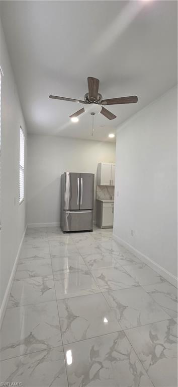 598 2nd Street Southeast Naples, FL 34117 - Photo 35 of 40 Unfurnished room featuring ceiling fan and light marble finish flooring