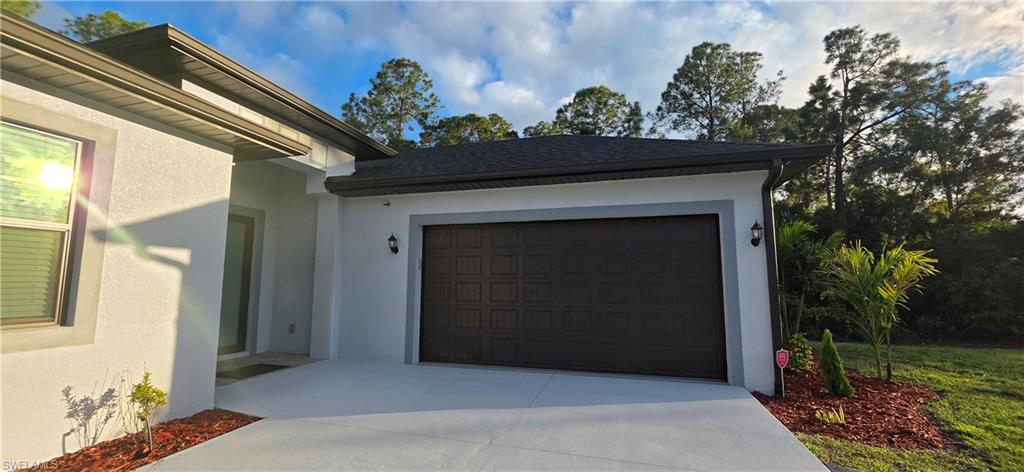 598 2nd Street Southeast Naples, FL 34117 - Photo 6 of 40 Garage featuring driveway
