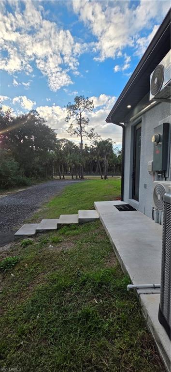 598 2nd Street Southeast Naples, FL 34117 - Photo 7 of 40 View of grassy yard featuring a patio and view of scattered trees