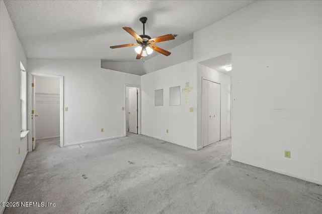 an empty room with fan and a ceiling fan