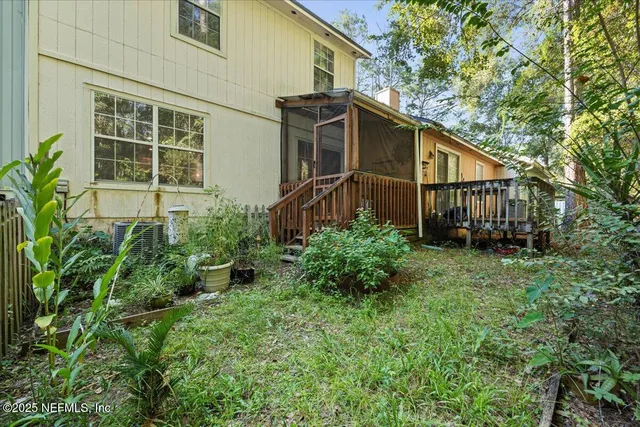 a view of a house with brick walls and flower plants
